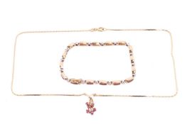 A ruby and diamond bracelet and a ruby pendant necklace; the bracelet featuring alternating panels o
