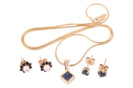 A sapphire and diamond-set rhombus pendant, set in a yellow metal mount stamped '18K', to a yellow m