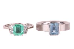 An aquamarine ring and a synthetic emerald and diamond ring; the single stone aquamarine ring set wi
