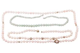 A single row coral bead necklace, 65cm long, the pale pink to cream coloured beads with four spheric