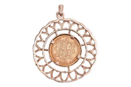 An 1884 Victoria young head half sovereign, mounted in a round pierced pendant of floral design; 10.