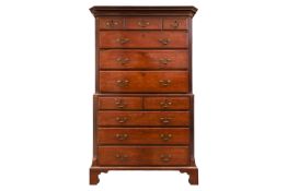 A George III mahogany chest on chest with canted and fluted corners, the upper carcass with three sh