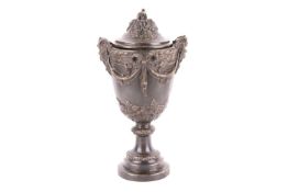 A patinated bronze Neoclassical urn and cover, 20th century, with fruiting vine finial, masked handl
