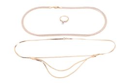 Two 9ct gold necklaces and a diamond solitaire ring; the first necklace consists of a flat herringbo