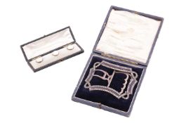A Victorian buckle and a set of dress studs; the buckle designed as a continuous ribbon set with pas