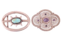 Two gem-set buckles; the first buckle of quatrefoil form, decorated with openwork filigree design an
