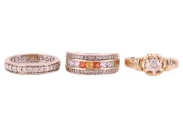 Three gem-set rings comprising a diamond-set full eternity ring in white metal tested as 9ct gold, s