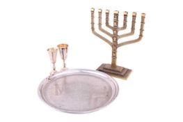 Two silver kiddish cups, together with a waiter and a base metal candelabrum; both cups have been st