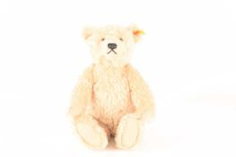 A blonde Steiff bear made by Steiff as a replica of the 1920s classic design, stitched nose, fully j