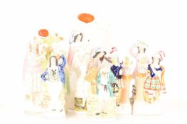 A collection of Staffordshire and Staffordshire style Flat Back figurines comprising a pair of figur