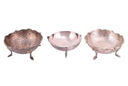 A pair of Arts and Crafts silver bonbon dishes, on four feet, with planished finish, hallmarks for E