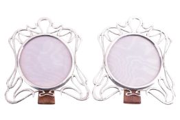A pair of silver Art Nouveau photo frames, of abstract design, 17.5 x 16cm, the circular aperture me