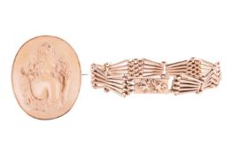A Victorian lava cameo brooch and a gate link bracelet; the lava cameo featuring a young lady with v