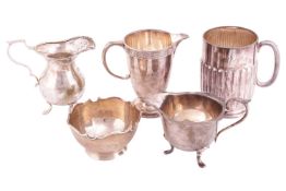 A small collection of 20th-century silver, comprising two cream jugs, a milk jug, a beaker and a bon