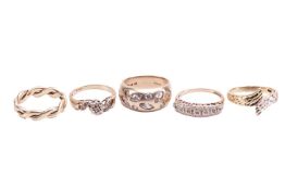 A collection of five 9ct yellow gold rings comprising a woven-style band, size M1/2, a gypsy-set rin