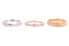 Three 18ct gold rings; to include a diamond-set dress ring in 18ct rose gold, size L; a channel-set 
