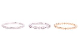 Three 18ct gold rings; to include a beaded design thin wedding band in 18ct yellow gold, size M; a d