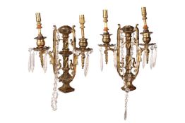 A pair Neo neo-classical gilt brass two-sconce wall lights with central columns, each branch with br
