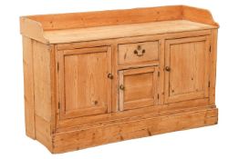 A North Country pine dresser, the three-quarter raised gallery over a central drawer and panelled cu