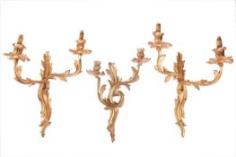 A pair of Louis XV-style ormolu effect double sconce wall lights with foliate scroll arms and drip p