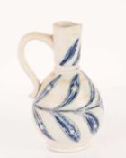 A 19th-century Doulton Lambeth stoneware jug, with blue-painted leaf decoration on an off-white grou