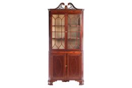 An Edwardian mahogany and marquetry inlaid free-standing double corner display cabinet, by Arthur Jo