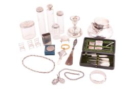 A quantity of items to include a mother-of-pearl cased sewing set, a set of five silver mounted dres