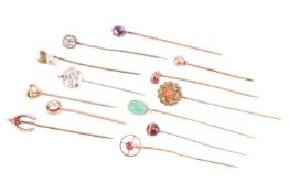 A collection of thirteen gem set stick pins; including a chrisoprase and diamond pin in yellow metal