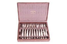 A Continental cutlery set, comprising of twelve knives and eleven three-pronged forks, the filled ha