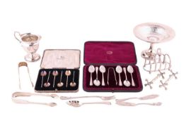 A cased set of six silver teaspoons with sugar tongs decorated with bright-cut flowers and shell-sha