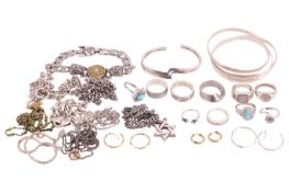 A collection of mixed jewellery items including a silver triple interlocking bangle, a stylised silv