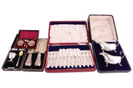 A cased pair of pepperettes, a boxed set of egg cup and spoon with gilt bowl and loaded base, a case