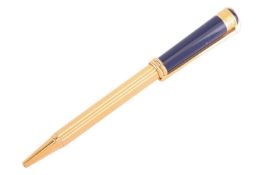 Christian Dior - a twist action ballpoint pen with a navy blue cap, yellow-tone reeded barrel and cl