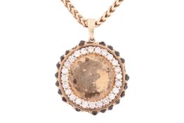 A diamond-set medallion pendant on chain, the circular pendant set with a frame of diamonds with the