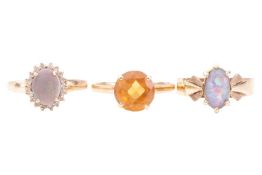 A collection of three rings; including an opal and diamond cluster ring, marked '9k', ring size S, a