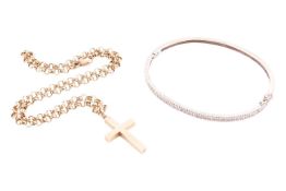 A diamond set bangle and a gold cross on a chain, the white metal bangle tests as 9ct, formed from a