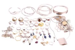 A quantity of white metal jewellery, including examples of bangles, gem-set earrings, pendant on cha