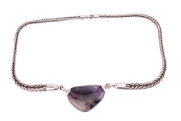 A Blue John pendant necklace, comprising a freeform polished Blue John, attached to a silver taperin