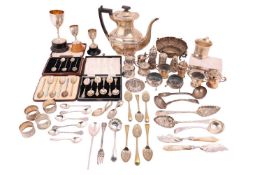 A mixed collection of silver comprising a silver coffee pot with an ebonised handle, a silver mug wi