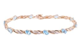 A gem-set line bracelet in 9ct gold, of twisted design, interspaced with oval-cut sky blue topaz in 