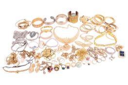 A collection of gold-toned base metal jewellery, to include closed bangles set with polychromatic pa