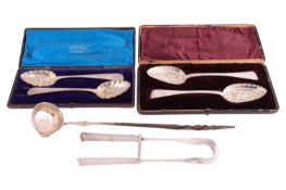 A pair of French asparagus servers, handle decorated with vacant oval cartouches surrounded with fol