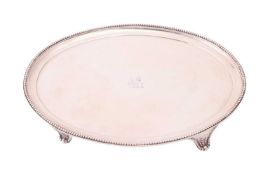 A George III oval salver by Benjamin Laver, London 1784, crested at the centre, decorated with a bea