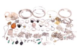 A large quantity of jewellery items, including examples of a three-tone metal bracelet with floral c