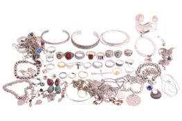 A large quantity of white metal jewellery; to include examples of a Gucci Ghost Aureco ring in size 