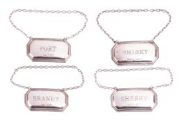 A set of four decanter labels; sherry, whiskey, brandy and port, each measuring 5.2 x 2.8mm, with ha