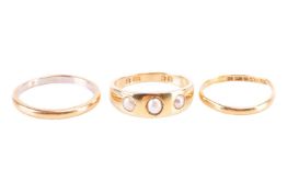 Three rings comprising an 18ct gold pearl set gypsy ring, a Platinum and 22ct gold wedding band and 