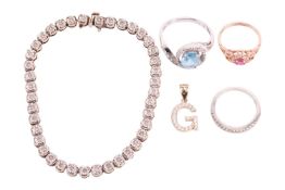 A diamond-set line bracelet, three gem-set rings and a pendant; the line bracelet illusion-set with 