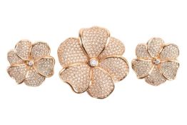 Christian Dior - a pair of floral clip-on earrings and a matching brooch, naturally sculpted, encrus