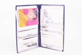 A varied collection of signed entertainment personality photographs and postcards, contained in a sm